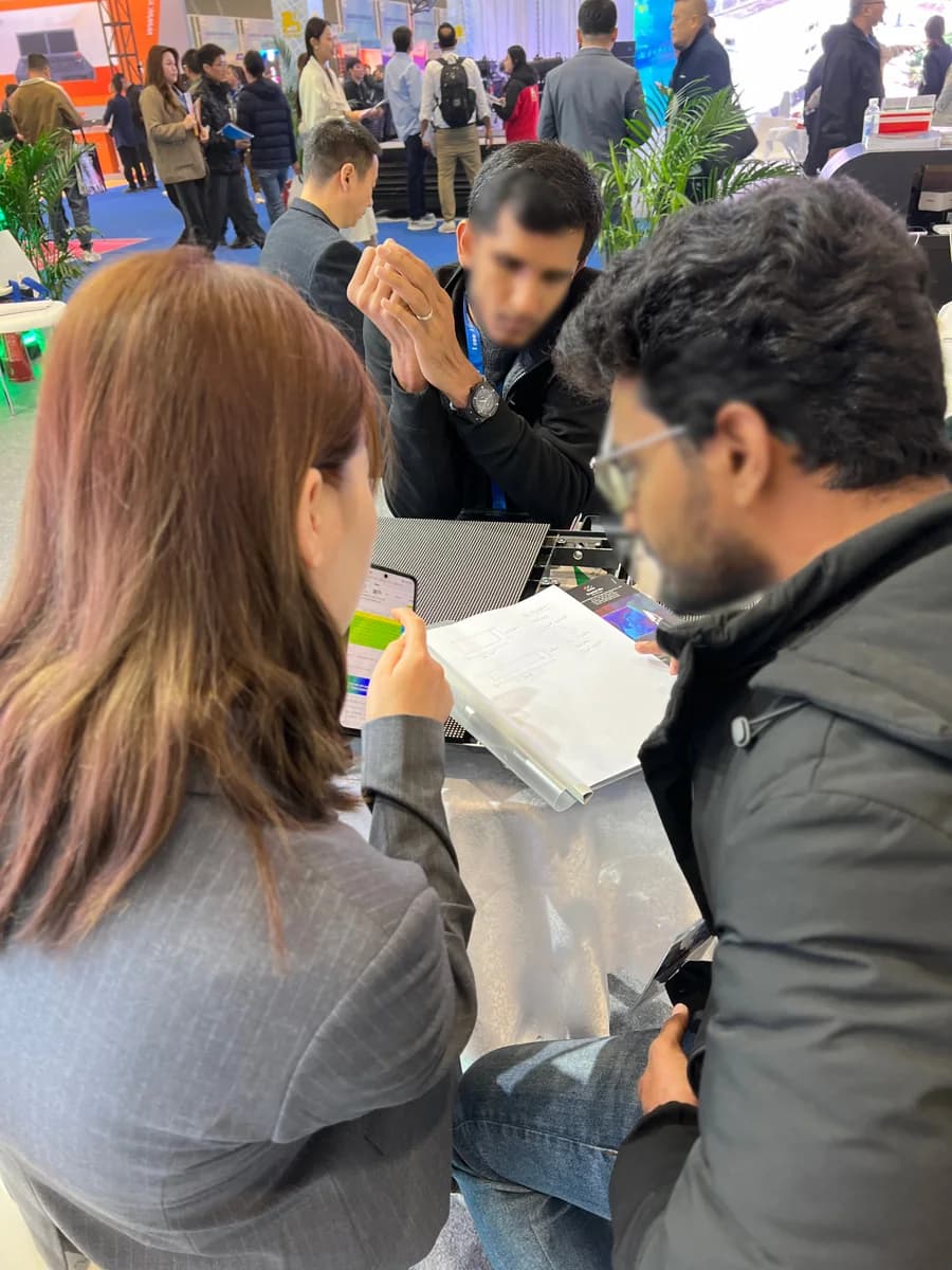 Stellux team reviewing an LED display project with international visitors