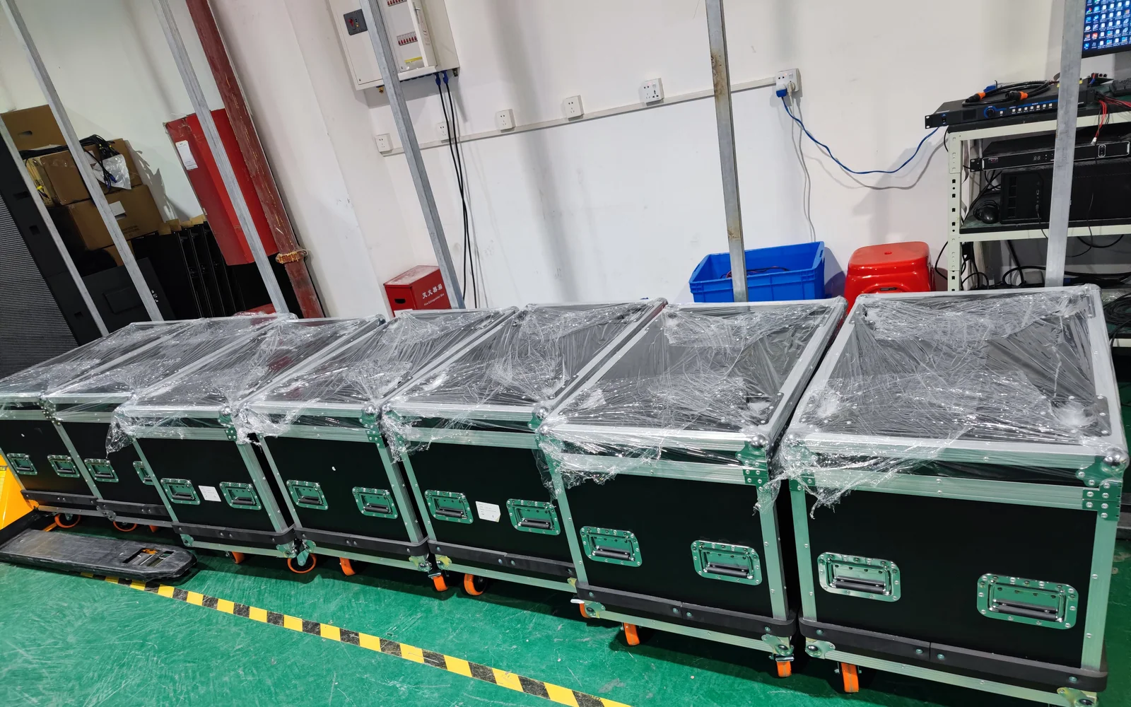 Protected LED flight cases staged in a row before dispatch